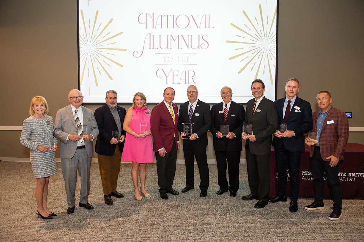 Mississippi State University recognized Bryan Wilson, center, as its National Alumnus of the Year during the May Alumni Associat