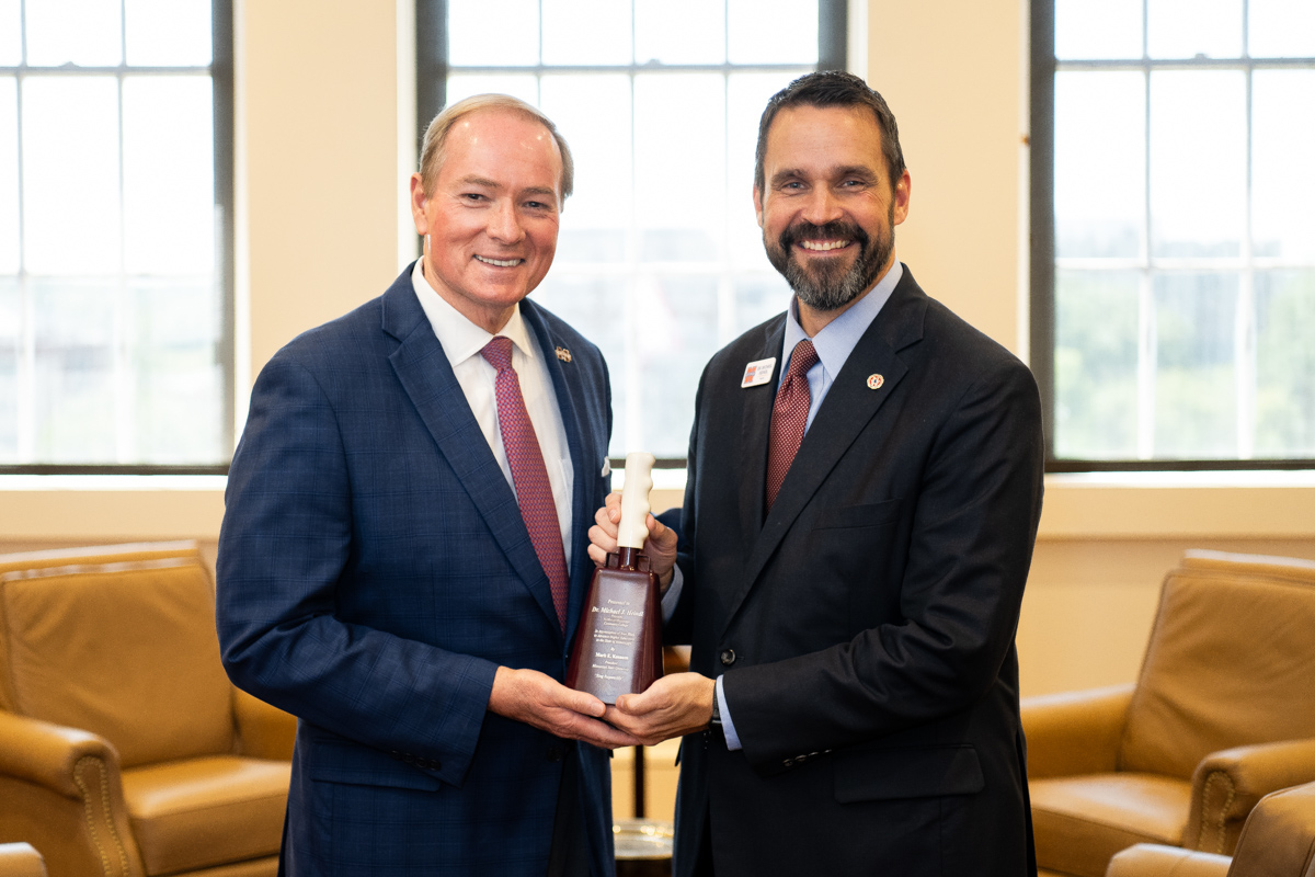 Northwest Mississippi Community College President Michael Heindl, right, was the recipient of an engraved cowbell from MSU